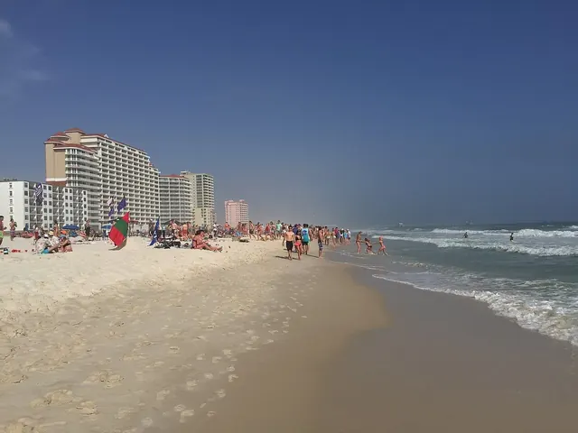 Choppy channel of water flowing out from a sandy beach